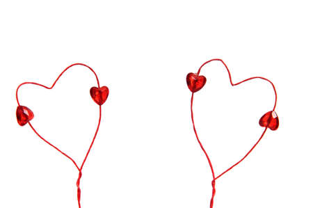 Two Valentine hearts made of  red wire with little red heart beads onの写真素材