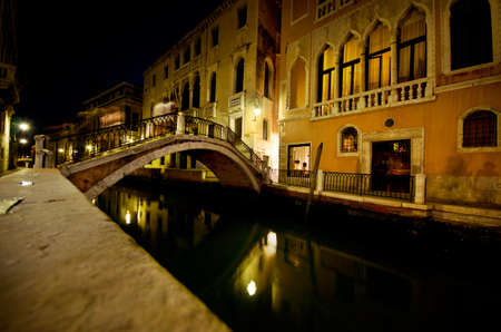 Canal with a bridge in Venice at night.の写真素材