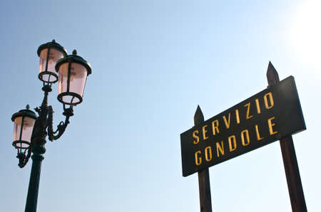 Pink lantern and infotmation sign at the San Marco square, Venice, Italyの写真素材