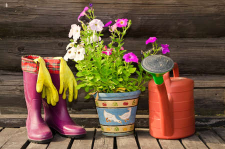 Garden tools (flower pot, watering can/ pot and rubber boots) horizontal imageの写真素材