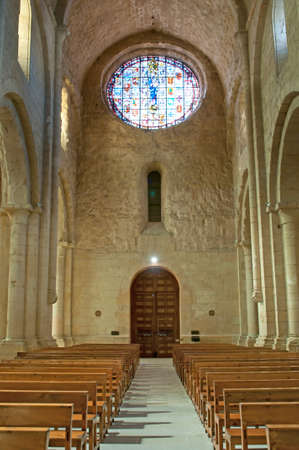 Rows of  wooden church benches on both sides of the aisle.のeditorial素材