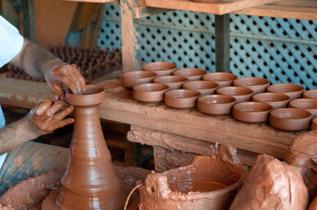 Potter's hands, creating an earthen jar on the spinning wheelのeditorial素材