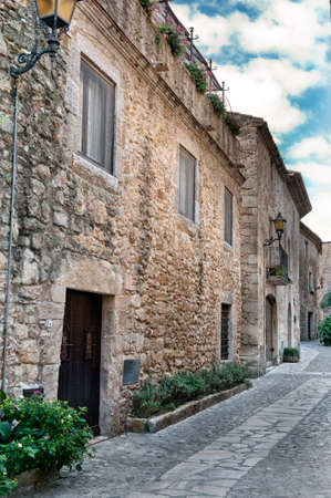 Narrow cobbled street in the medieval city of Peratallada, Spainの写真素材