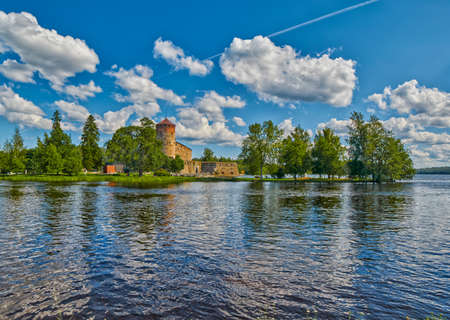 Lake view with reflections of Olavinlinna Olofsborg, the 15th-century medieval three-tower castle located in Savonlinna, Finland.のeditorial素材