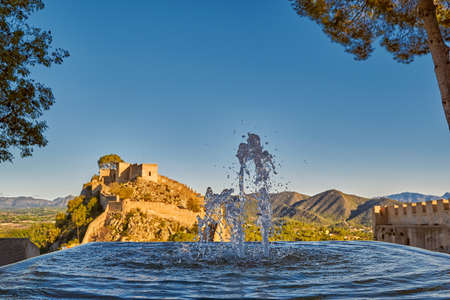 Beautiful Splashing fountain in Xativa Castle of Spain at Sunsetの写真素材
