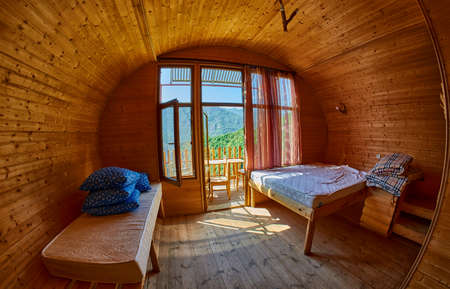 Interior of wooden cottage family room with mountain view