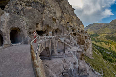 Young woman in famous Vardzia Cave Town Monastery Landmark of Georgiaのeditorial素材