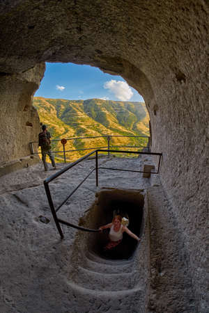Young woman in famous Vardzia Cave Town Monastery Landmark of Georgiaのeditorial素材