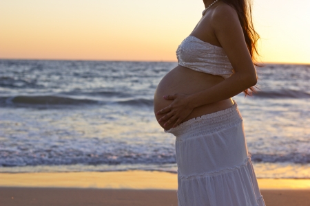 Maternity   Pregnant woman with the beach in the background の写真素材