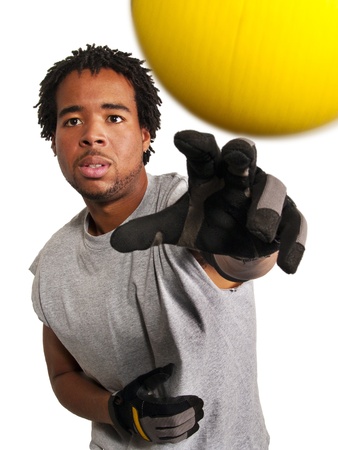 dodge ball player throwing a yellow ball at viewerの写真素材