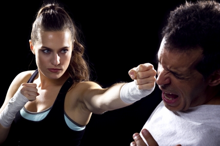 female MMA fighter fighting a manの写真素材