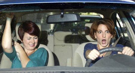 reckless driver and scared female passenger in a carの写真素材