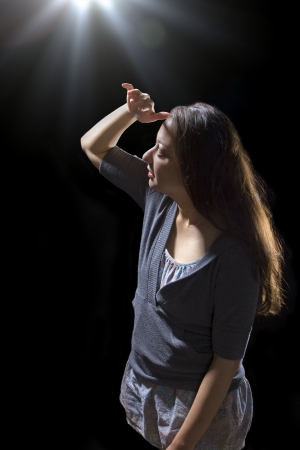 young woman seeing bright glowing orbs from aboveの写真素材