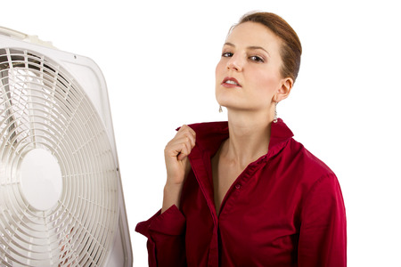 Businesswoman cooling off with a fan の写真素材