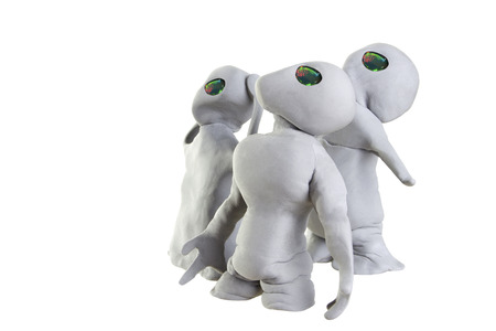 gray alien made of clay on a white background