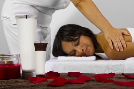 spa products on foreground, masseuse and patient on backgroundの写真素材