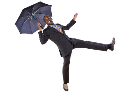 young black businessman dancing with an umbrellaの写真素材