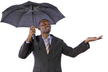 young black businessman looking confident under an umbrellaの写真素材