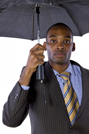 young black businessman looking confident under an umbrellaの写真素材