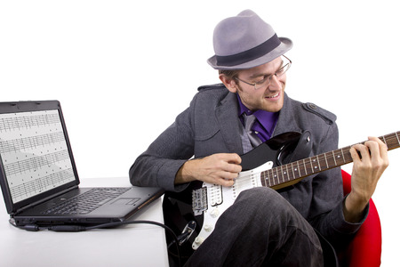 Guitarist looking at tablature online.の写真素材