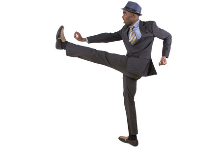young black businessman doing a karate kickの写真素材