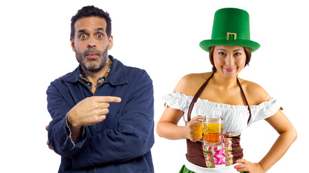 young female dressed in St Patty's costume serving customersの写真素材