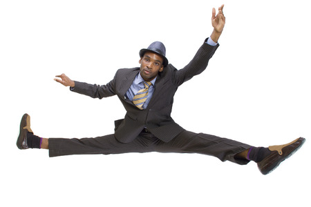 athletic black man in a suit doing the splits