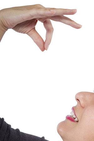 close up of woman eating invisible food for compositesの写真素材