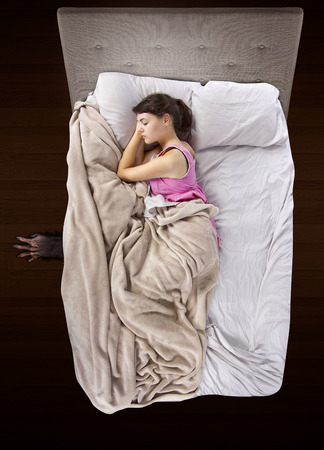 monster coming out from under teenage girls bedの写真素材