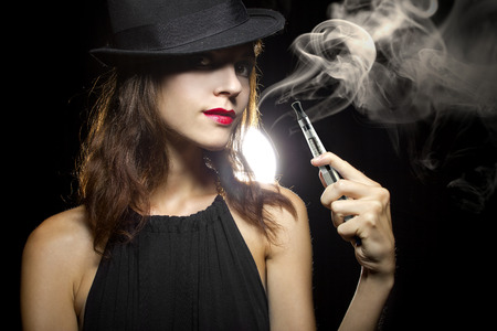 woman smoking or vaping an electronic cigarette to quit tobacco