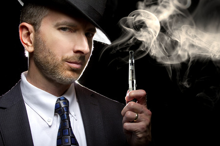 male smoking a vapor cigarette as an alternative to tobaccoの写真素材