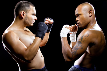 black boxer posing with latino opponent on a black background