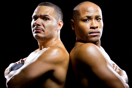 black boxer posing with latino opponent on a black backgroundの写真素材