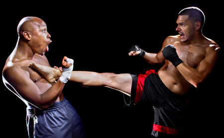 mma fighter performing a counter attack from a kickの写真素材