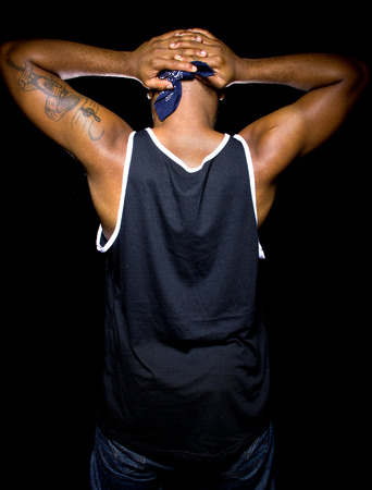 Black man with hands up behind his back is under arrestの写真素材