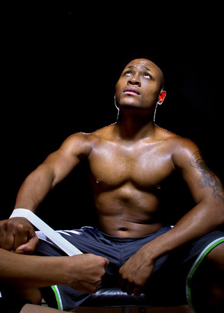 boxer or mma fighter looking up in prayer for victory while preparingの写真素材