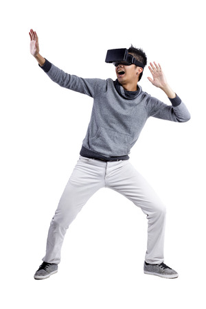 Male immersed in interactive virtual reality video game doing gestures on white background