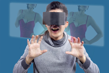 Male watching 3D virtual reality porno movie with headsetの写真素材