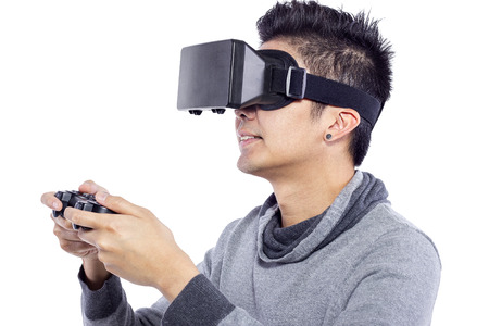 Man wearing virtual reality goggles watching movies or playing video gamesの写真素材