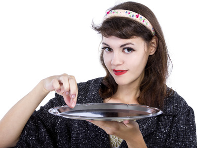 Retro style woman pretending to pickup something from a tray for compositesの写真素材