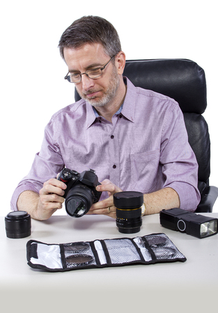 Professional photographer showing how to use camera gearの写真素材