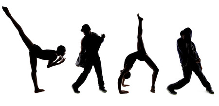 Silhouettes of dancers posing with classical ballet and modern hip hop danceの写真素材