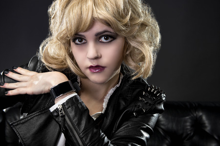 Female wearing dark goth leather style with matching black smartwatch wearable techの写真素材