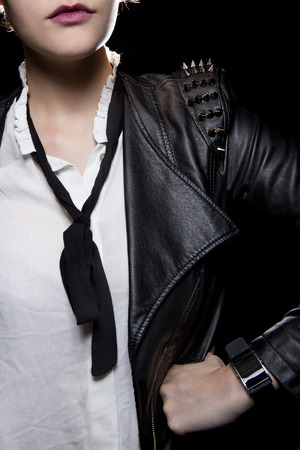 Black smart watch on a female model wearing stylish punk style leatherの写真素材