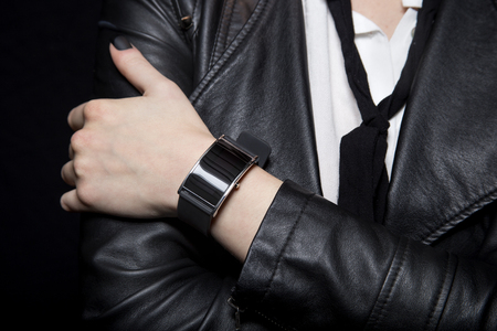 Black smart watch on a female model wearing stylish punk style leatherの写真素材