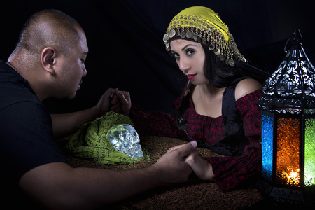 Psychic or fortune teller gypsy with a client doing a seance telepathic ritualの写真素材