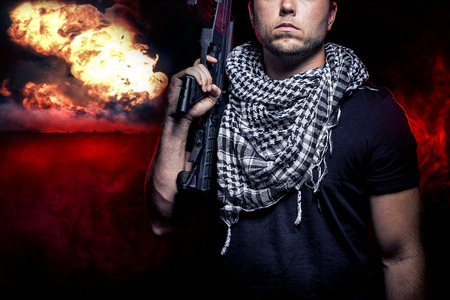 Soldier with a gun surviving bombs that are weapons of mass destruction or a nuclear war. The image depicts warfare and apocalyptic WW3.の写真素材