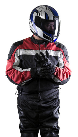 Man wearing a protective leather and textile racing suit for race cars and motorcycle motor sports.  The gear is armored with a helmet and worn by bikers and professional drivers. The man is isolated on a white background.の写真素材