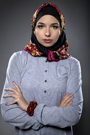 Fashion model wearing hijab for conservative modern clothing mostly associated with muslims, middle eastern and east european culture.  The outfit depicts the traditional headscarf in vogue style.の写真素材