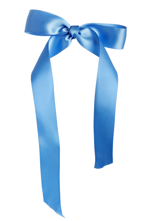 Satin cloth tied as a bow to make a birthday gift ribbon used for presents or wedding decoration.  The design is isolated on a white background.の写真素材